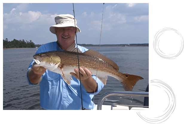 A man holding a fish on the boat